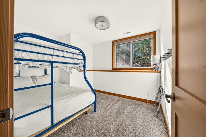Bunk room with a single-over-double bunk bed