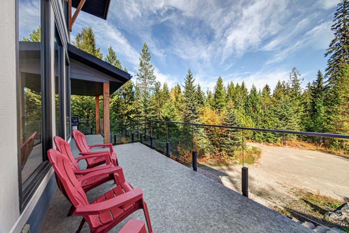 Red Muskoka chairs on the deck in the sun