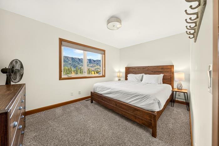 King bedroom with a window looking at the mountains