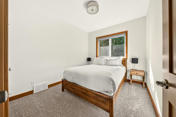 Queen bedroom with wood bed frame